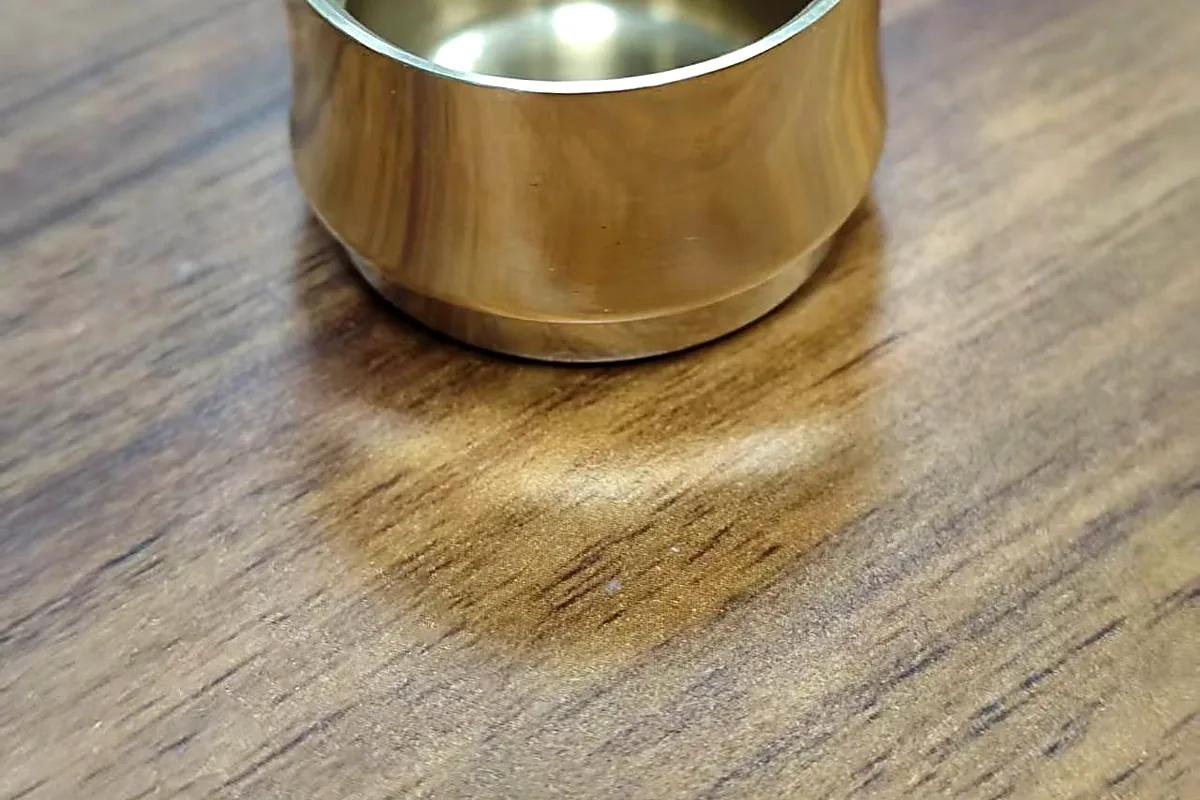 Mirror polished outer surface of a CNC machined brass sleeve