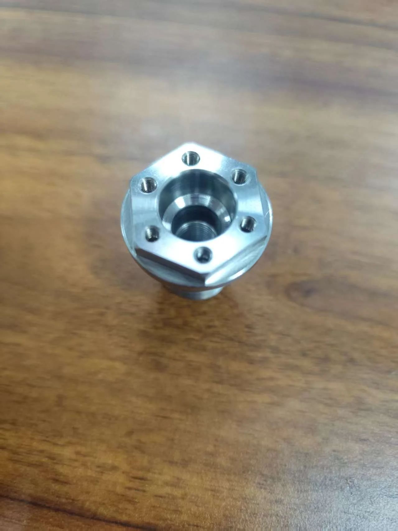 CNC turned steel component with machined bores and threaded holes