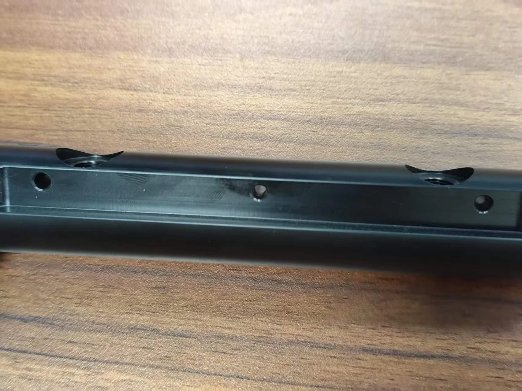 Position-related side holes and threaded features on a machined POM component