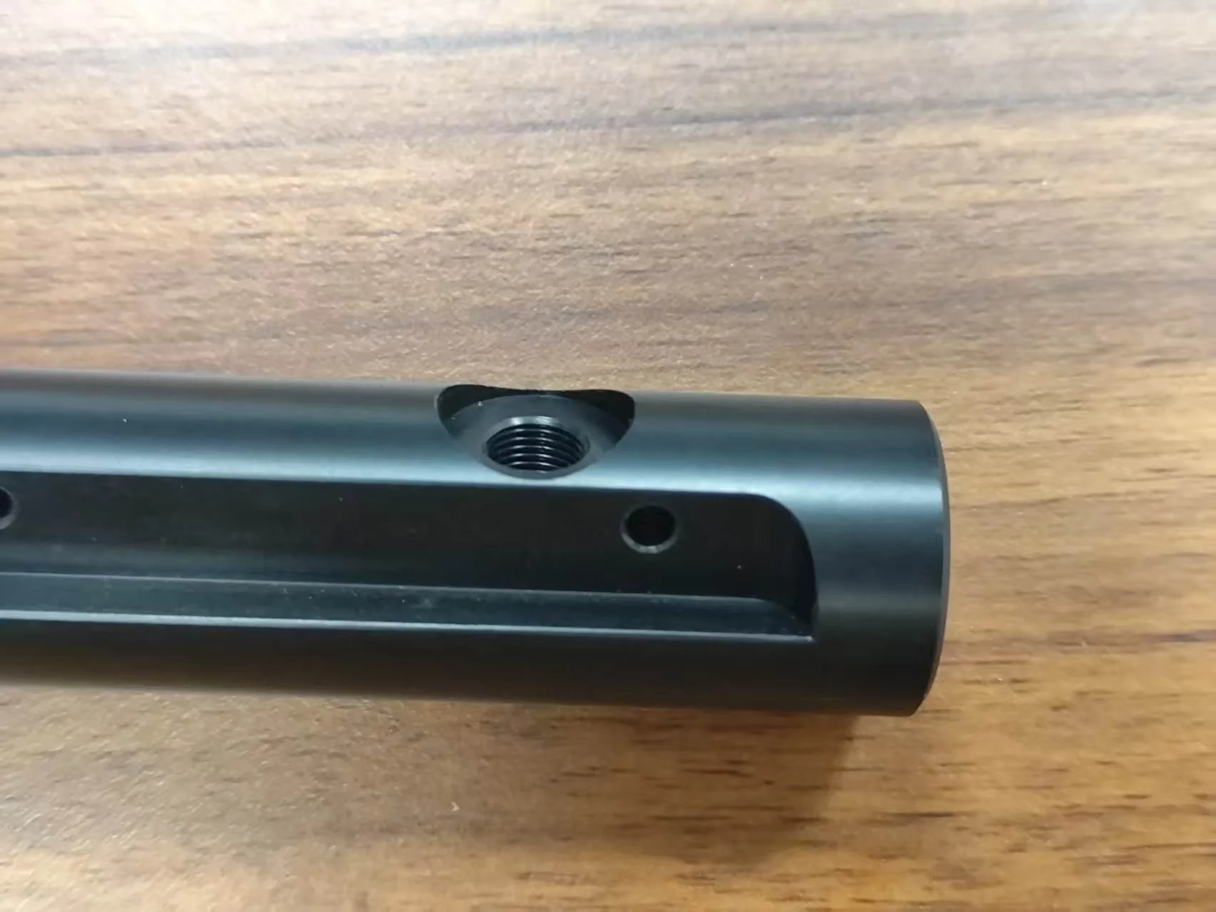 Turn-milled black POM cylindrical component with cross hole and counterbore